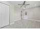 This bedroom has wood-look floors, a ceiling fan, and ample storage with closet space at 1102 Berkley Ln, Winter Haven, FL 33880