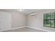 Bright bedroom with neutral walls, modern flooring, and a large window for natural light at 1102 Berkley Ln, Winter Haven, FL 33880