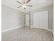Spacious bedroom featuring wood-look flooring, a ceiling fan, and a large closet for ample storage at 1102 Berkley Ln, Winter Haven, FL 33880