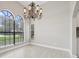 Bright dining room featuring elegant chandelier and beautiful windows at 1102 Berkley Ln, Winter Haven, FL 33880