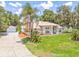 Well-kept home with a lovely front yard, palm tree, and a detached garage at 1102 Berkley Ln, Winter Haven, FL 33880