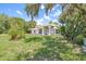 Landscaped front yard of a charming home with mature landscaping and trees at 1102 Berkley Ln, Winter Haven, FL 33880