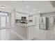 Kitchen featuring granite counters, stainless appliances, white cabinets, and modern fixtures at 1102 Berkley Ln, Winter Haven, FL 33880