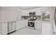 Modern kitchen with stainless steel appliances, granite counters, and white cabinets at 1102 Berkley Ln, Winter Haven, FL 33880