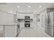 Renovated kitchen features stainless steel appliances, granite counters, and white cabinetry at 1102 Berkley Ln, Winter Haven, FL 33880