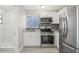 Updated kitchen with stainless steel appliances, granite countertops, and a modern backsplash at 1102 Berkley Ln, Winter Haven, FL 33880