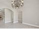 Open living room with arched doorways and tile flooring at 1102 Berkley Ln, Winter Haven, FL 33880