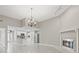 Open concept living area with fireplace, modern lighting, and open access to the kitchen with stainless appliances at 1102 Berkley Ln, Winter Haven, FL 33880