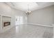Bright living room features a fireplace, tiled floors, high ceilings, and access to the backyard at 1102 Berkley Ln, Winter Haven, FL 33880