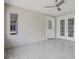 This patio offers natural light, has neutral tones, tile flooring, and access to the outdoors at 1102 Berkley Ln, Winter Haven, FL 33880