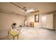 Unfinished basement featuring concrete flooring, block walls, an exterior door, and plenty of open space at 1125 Blackjack Ridge St, Minneola, FL 34715