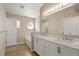 Bathroom features a bathtub and dual sink vanity with granite countertops at 1125 Blackjack Ridge St, Minneola, FL 34715
