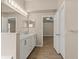 Bathroom with double vanity sink and tiled floor leading to a bedroom at 1125 Blackjack Ridge St, Minneola, FL 34715