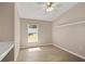Bright bedroom featuring wood-look flooring, a ceiling fan, neutral paint, and a window with natural light at 1125 Blackjack Ridge St, Minneola, FL 34715
