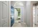 Bright foyer featuring tile flooring, a modern front door, and a glimpse of the home's interior at 1125 Blackjack Ridge St, Minneola, FL 34715