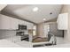 Updated kitchen featuring white cabinetry, stainless steel appliances, tile floors, and sleek countertops at 1125 Blackjack Ridge St, Minneola, FL 34715