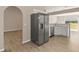 Stainless steel refrigerator complementing the kitchen and dining area with tiled floors at 1125 Blackjack Ridge St, Minneola, FL 34715