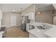 Modern kitchen featuring quartz countertops, stainless steel appliances, and tile floors at 1125 Blackjack Ridge St, Minneola, FL 34715