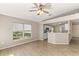 Cozy living area featuring tile floors, a large window, and an open-concept layout with a view of the kitchen at 1125 Blackjack Ridge St, Minneola, FL 34715