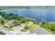 Aerial view features home with lake view, dock, green lawns and landscaping at 141 Minniehaha Cir, Haines City, FL 33844