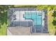 Aerial view of screened pool, pool deck, and patio area, with house roof partially visible at 141 Minniehaha Cir, Haines City, FL 33844