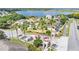 Aerial view of community entrance with palm trees, landscaping, and lake in the background at 141 Minniehaha Cir, Haines City, FL 33844