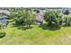 Wide aerial shot showing a spacious, grassy backyard, pool and mature trees around home at 141 Minniehaha Cir, Haines City, FL 33844