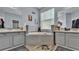 A luxurious bathroom featuring dual vanities, a soaking tub, and elegant tile work at 141 Minniehaha Cir, Haines City, FL 33844
