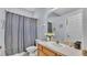 Bathroom showcasing a vanity with sink, toilet, and shower with gray curtain at 141 Minniehaha Cir, Haines City, FL 33844