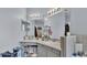 Bathroom vanity featuring double mirrors, granite countertop, cabinet storage, and decor accents at 141 Minniehaha Cir, Haines City, FL 33844