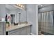 This bathroom has a vanity with modern fixtures and a tiled walk-in shower at 141 Minniehaha Cir, Haines City, FL 33844