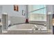 Bright bathroom with a large bathtub beneath a window, offering natural light and privacy at 141 Minniehaha Cir, Haines City, FL 33844