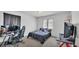 This bedroom features neutral carpet, light walls, large window, desk and is brightly lit at 141 Minniehaha Cir, Haines City, FL 33844