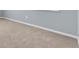 An empty room with wall-to-wall carpeting showing the neutral wall color and baseboard trim at 141 Minniehaha Cir, Haines City, FL 33844