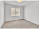 An empty bedroom with a window and neutral carpeting, ready for personalized decor at 141 Minniehaha Cir, Haines City, FL 33844