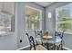 A quaint dining area features a glass table and metal chairs, perfect for enjoying casual meals with a view at 141 Minniehaha Cir, Haines City, FL 33844