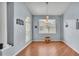Dining room with wood-look floors, decorative lighting, and a large window at 141 Minniehaha Cir, Haines City, FL 33844