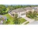 Aerial view showcasing the home's exterior, lawn, and well-maintained landscaping at 141 Minniehaha Cir, Haines City, FL 33844