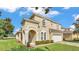 Stucco two-story home with well maintained lawn and two-car garage at 141 Minniehaha Cir, Haines City, FL 33844