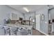 Spacious kitchen featuring a breakfast bar, stainless steel appliances, and modern grey cabinetry at 141 Minniehaha Cir, Haines City, FL 33844