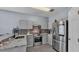 Modern kitchen boasts stainless steel appliances, sleek countertops, and stylish grey cabinetry at 141 Minniehaha Cir, Haines City, FL 33844