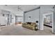 Comfortable living room with neutral tones and access to bedroom, foyer, and dining area at 141 Minniehaha Cir, Haines City, FL 33844