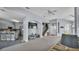 Open-concept living area with kitchen, staircase, and large tv viewing area at 141 Minniehaha Cir, Haines City, FL 33844