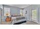 This primary bedroom is a comfortable space with carpet, a large bed and light blue walls at 141 Minniehaha Cir, Haines City, FL 33844