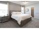 Spacious bedroom with tray ceiling, neutral paint, large bed with storage drawers, and two windows at 1449 Fleur Dr, Davenport, FL 33837