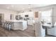 Spacious kitchen featuring a large island with seating, stainless steel appliances, and an adjacent dining area at 1449 Fleur Dr, Davenport, FL 33837
