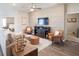 Inviting living room featuring neutral tones, stylish furnishings, a decorative wall, and an open floor plan at 1449 Fleur Dr, Davenport, FL 33837