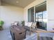 Cozy outdoor patio area with seating, a fire pit coffee table, and large sliding glass doors at 1449 Fleur Dr, Davenport, FL 33837