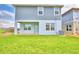 Spacious backyard with green lawn and new home under construction at 1497 Leamington Ln, Winter Haven, FL 33884