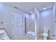 Bathroom featuring a walk-in shower with clear glass doors, white fixtures, and clean lines at 1497 Leamington Ln, Winter Haven, FL 33884